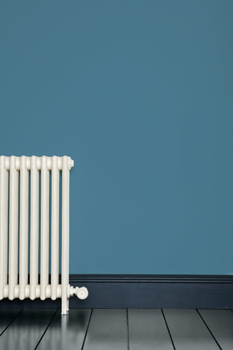 White radiator against a blue wall