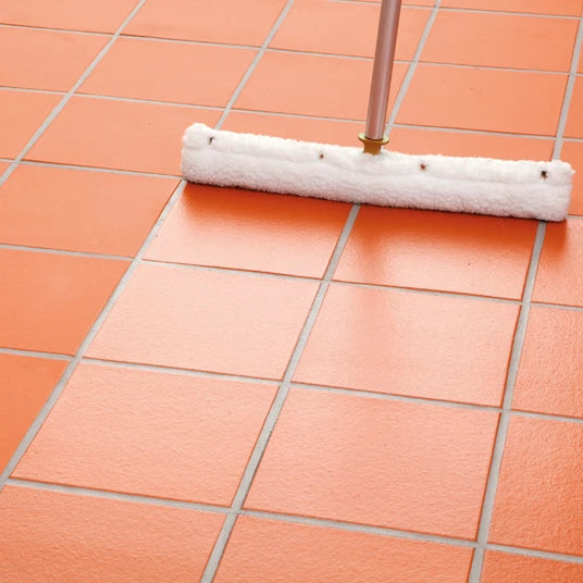 Roller cleaning a tiled floor