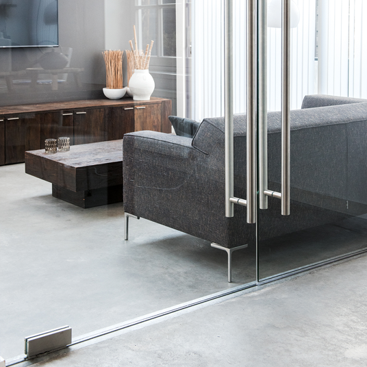 Modern living room with a gray sofa, wooden coffee table, and decorative items.