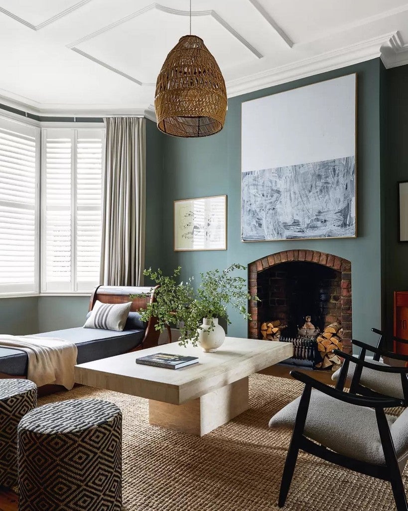 Living room with a fireplace, coffee table, and decorative items.