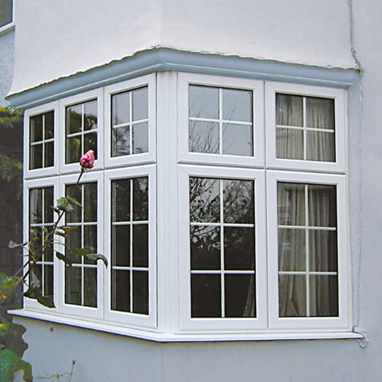 White bay window with glass panels on a house exterior