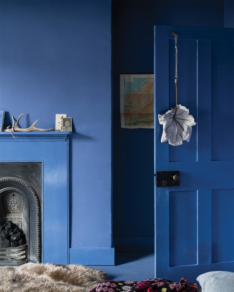 Blue wall with a fireplace and decorative items