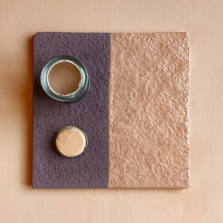 Textured square wall art with two circular elements on a beige background