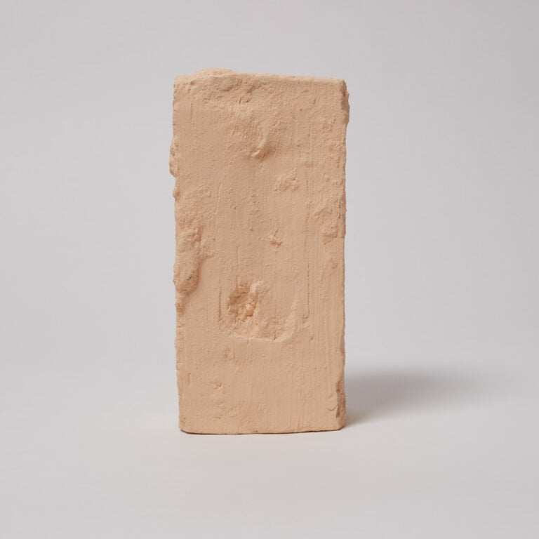 Rectangular beige brick on a light gray background