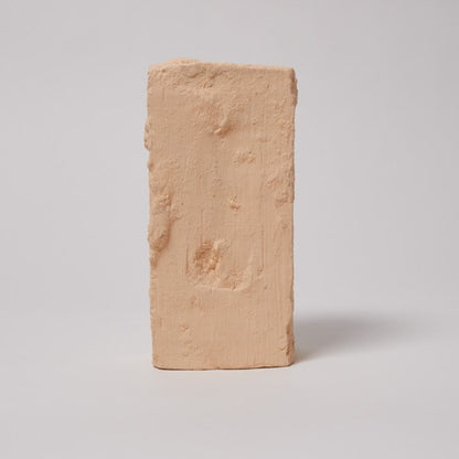 Rectangular beige brick on a light gray background