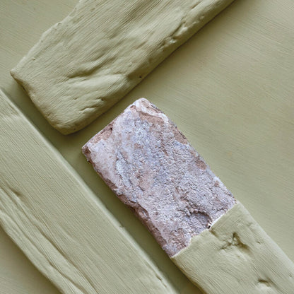 Two rectangular stone samples on a light green background