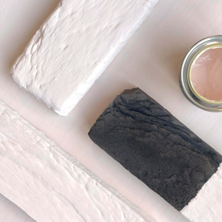 Bar of soap and a small container on a white surface