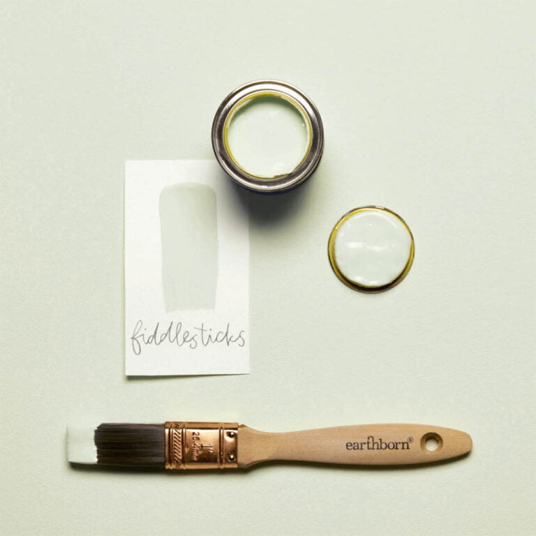 Paintbrush and paint can with 'earthborn' branding on a light green background