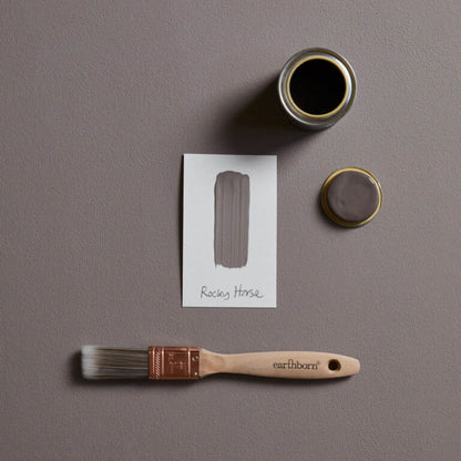 Paint can, brush, and color swatch on a gray background