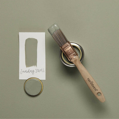 Paint brush and can with a color swatch on a green background