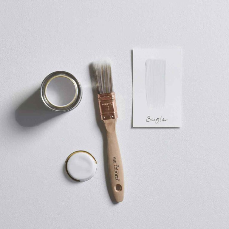 Paint can, brush, and card on a light gray background