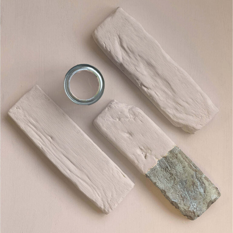 Three wooden blocks with a metal ring on a beige background