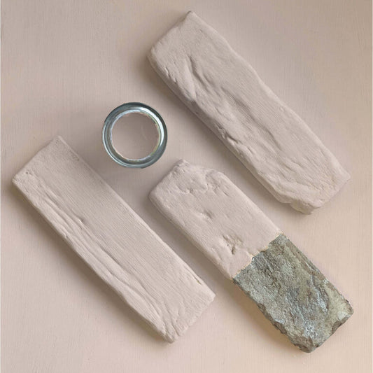 Three wooden blocks with a metal ring on a beige background