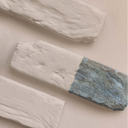 Three wooden planks with different finishes on a beige background