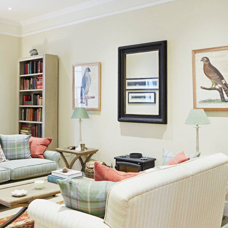 Living room with beige walls, a white sofa, and decorative elements.