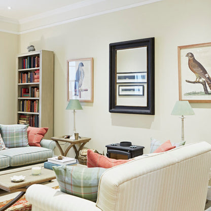 Living room with beige walls, a white sofa, and decorative elements.