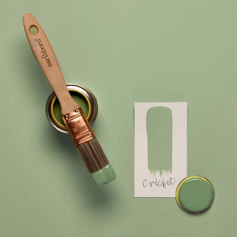 Paintbrush with green paint, paint can, and color swatch on a green background