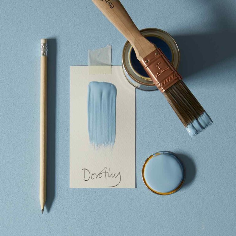 Paint can, brush, pencil, and swatch of Dov Algy blue paint on a light blue background