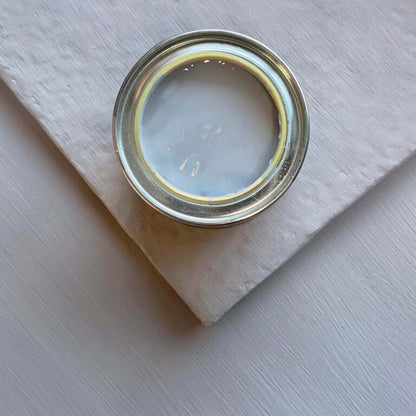 Metal can lid on a light wooden surface