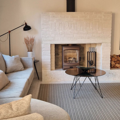 Modern living room with a fireplace, sofa, and coffee table.