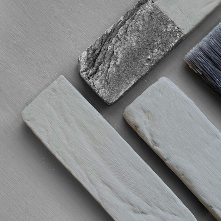 Decorative stones and a brush on a gray surface