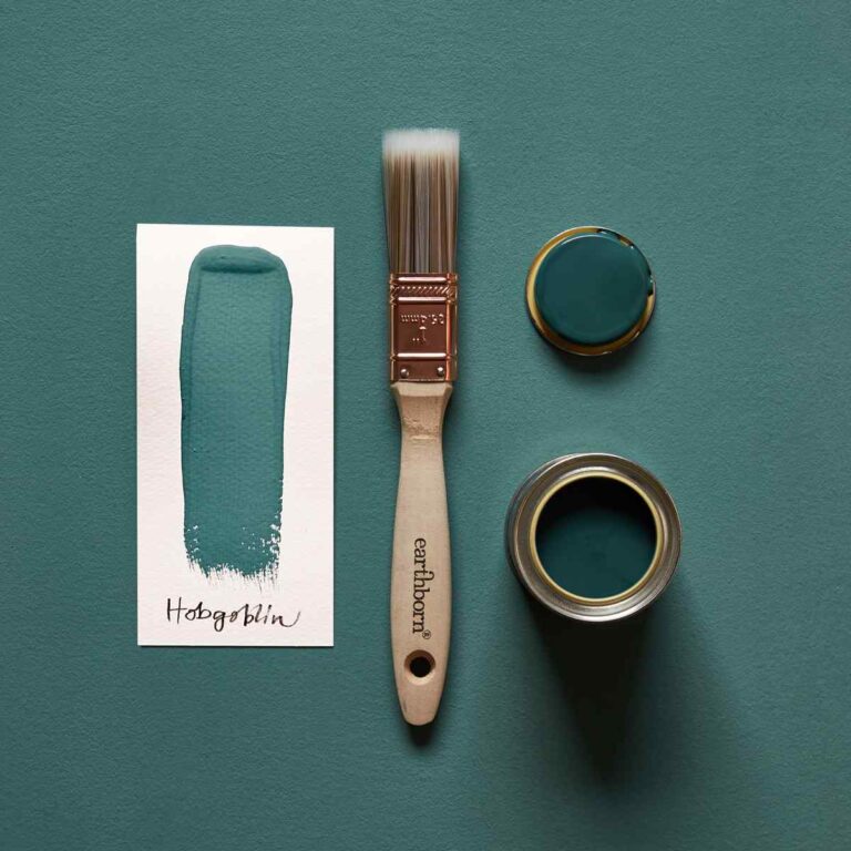 Teal paint swatch, brush, and can on a teal background