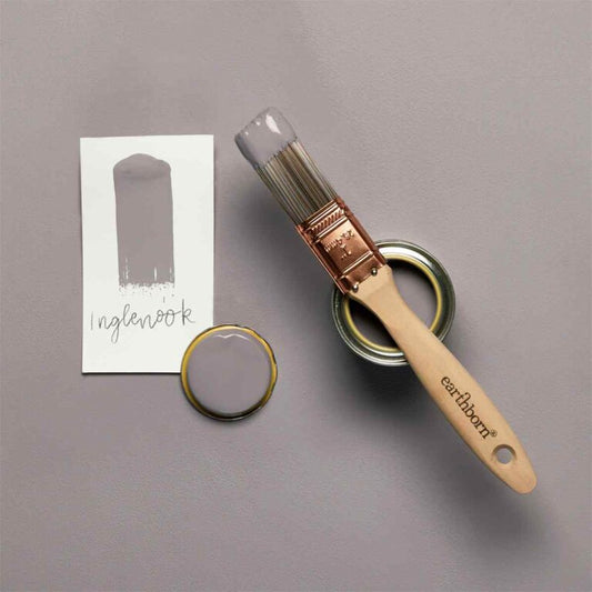 Paintbrush and paint can with color swatch on a gray background