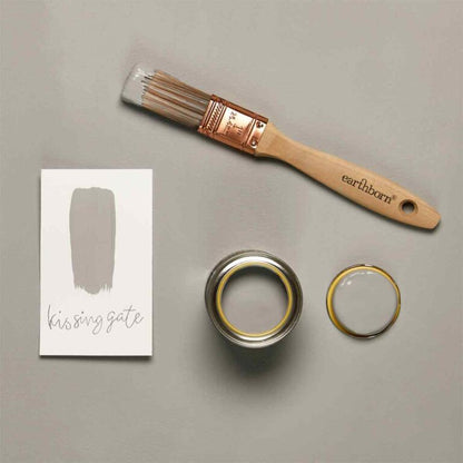 Paint brush, paint can, and color swatch labeled 'kissing gate' on a gray background