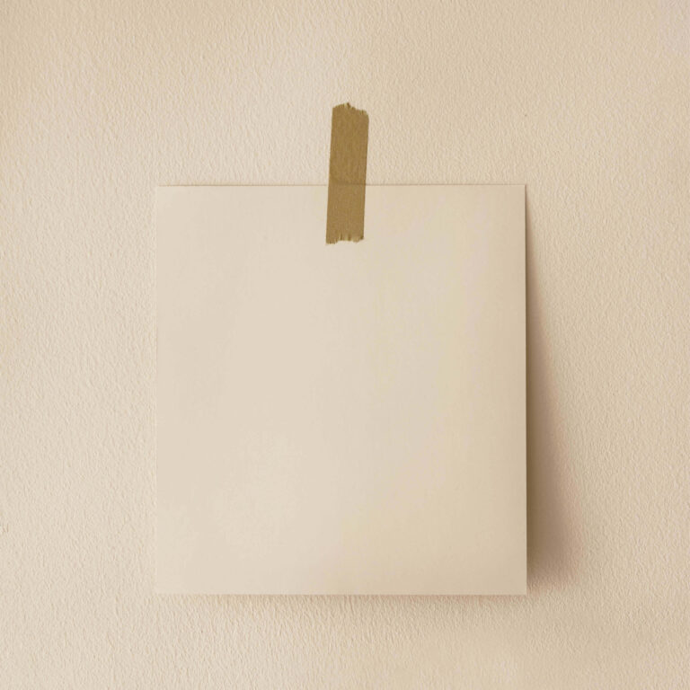 Beige square canvas with brown tape on a beige wall