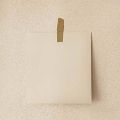 Beige square canvas with brown tape on a beige wall