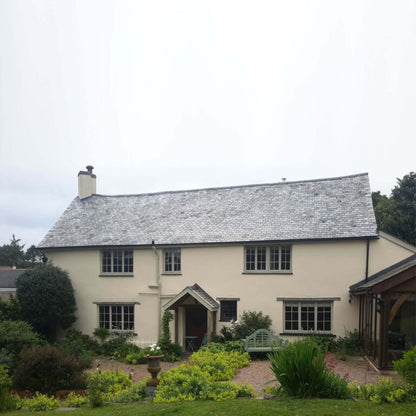 Traditional house with a garden on a cloudy day