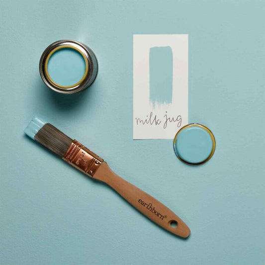 Paint can, brush, and color swatch on a light blue background