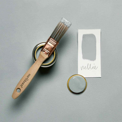 Paintbrush, paint can, and label on a gray background