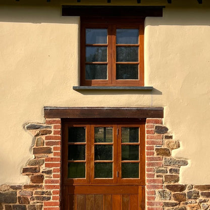Wooden door and window with stone foundation on a building exterior