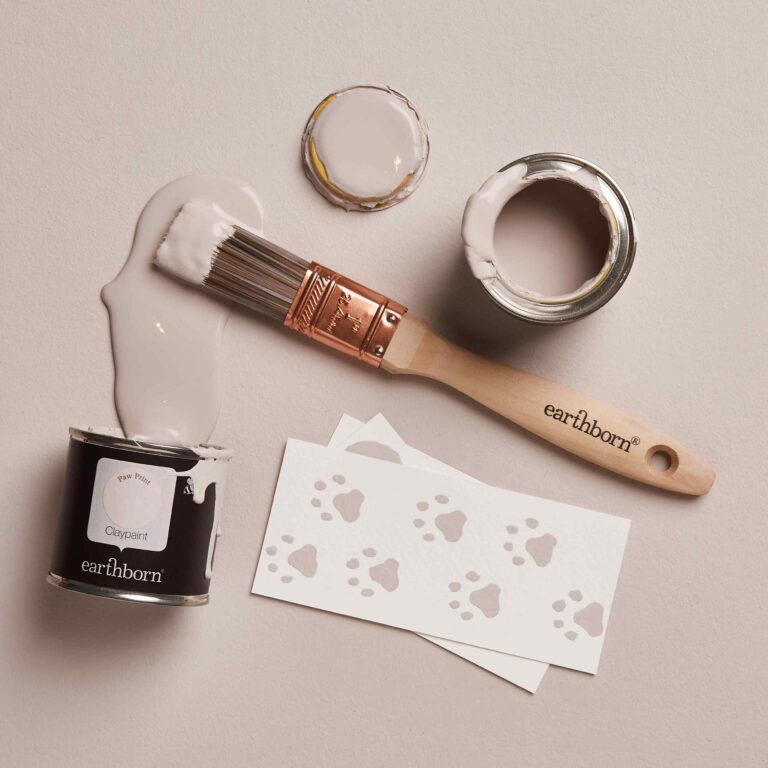 Paintbrush, paint containers, and stencils on a neutral background with 'earthborn' branding.