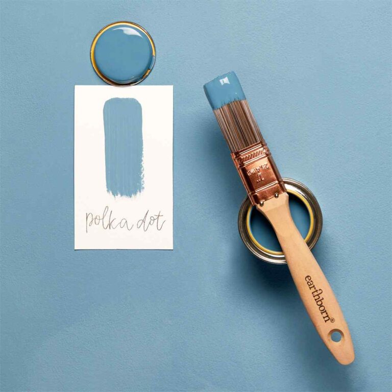 Paintbrush with blue paint, paint can, and color swatch on a blue background