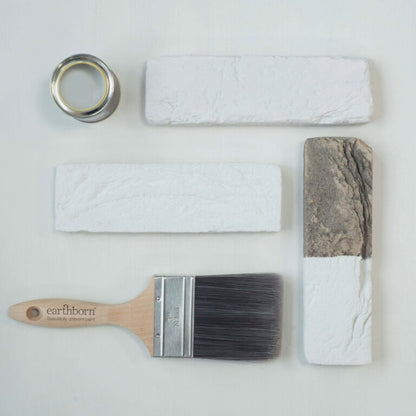Paintbrush, paint roller, and paint samples on a white background