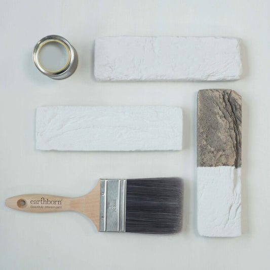 Paintbrush, paint roller, and paint samples on a white background