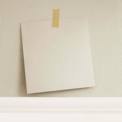 Beige envelope with gold tape on a textured beige wall