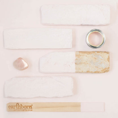 Collection of skincare products with 'earthborn' branding on a light pink background