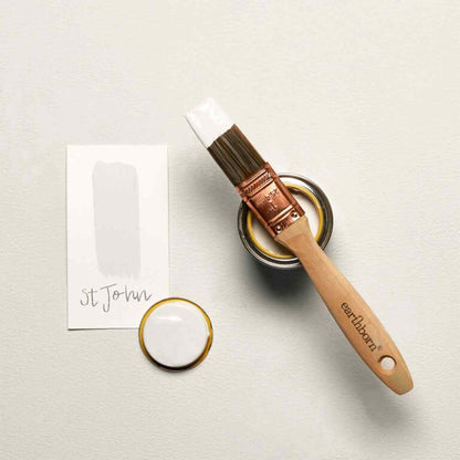 Paint brush and paint can on a light gray surface with 'earlham' branding.