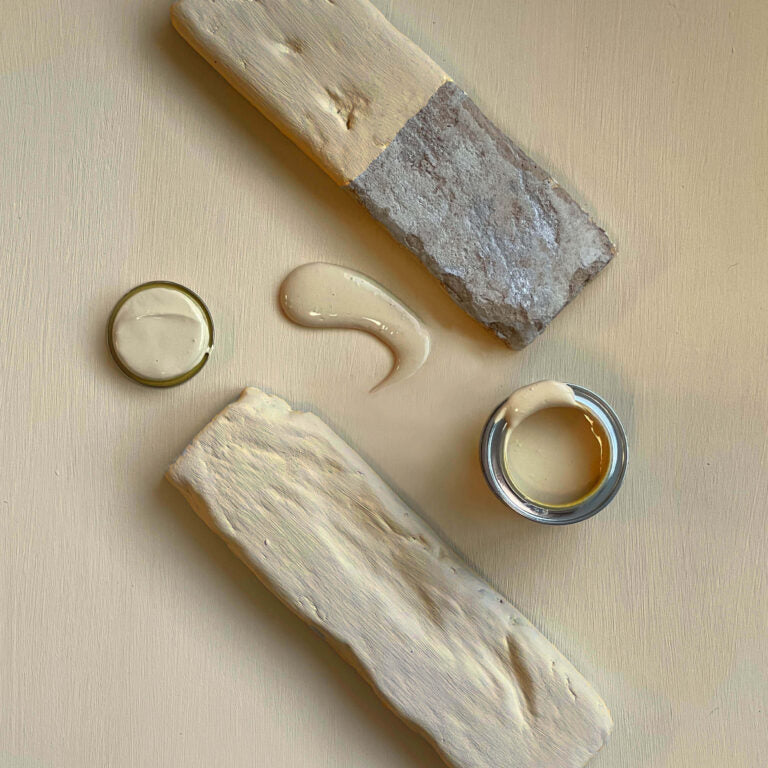 Wooden blocks with applied cream-like substance on a beige background