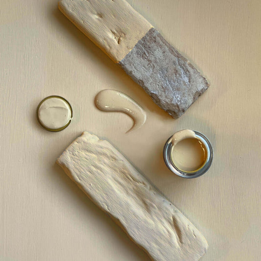 Wooden blocks with applied cream-like substance on a beige background