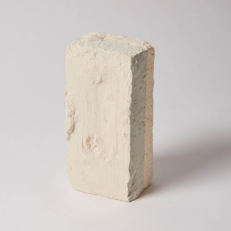 Concrete block with a visible two-tone color on a gray background
