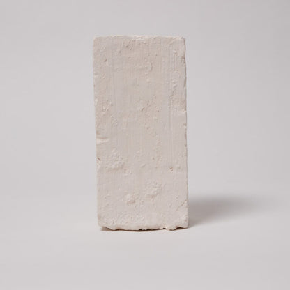 Rectangular beige stone block on a light gray background