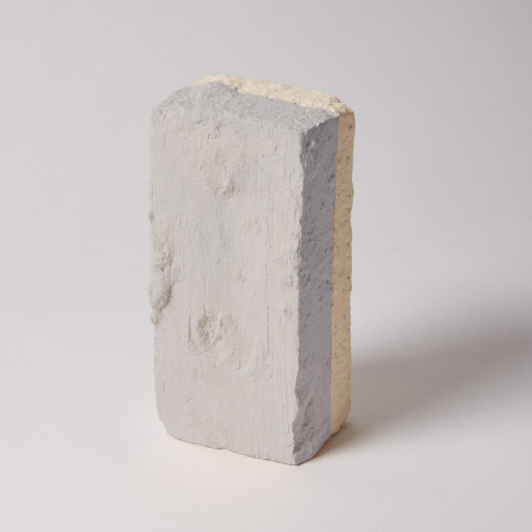 Concrete block with a gray and beige color gradient on a white background