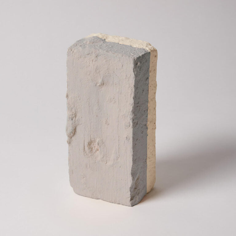 Concrete block with a gradient of gray and beige on a white background