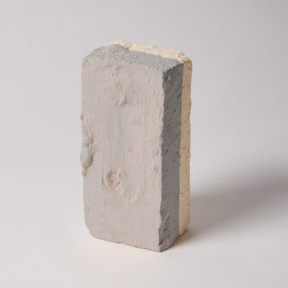Concrete block with a gradient of gray and beige on a white background