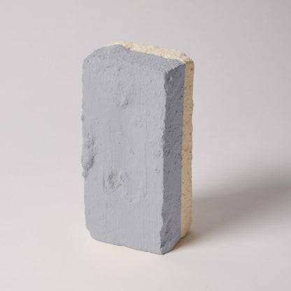 Concrete block with a gray and beige color on a light gray background