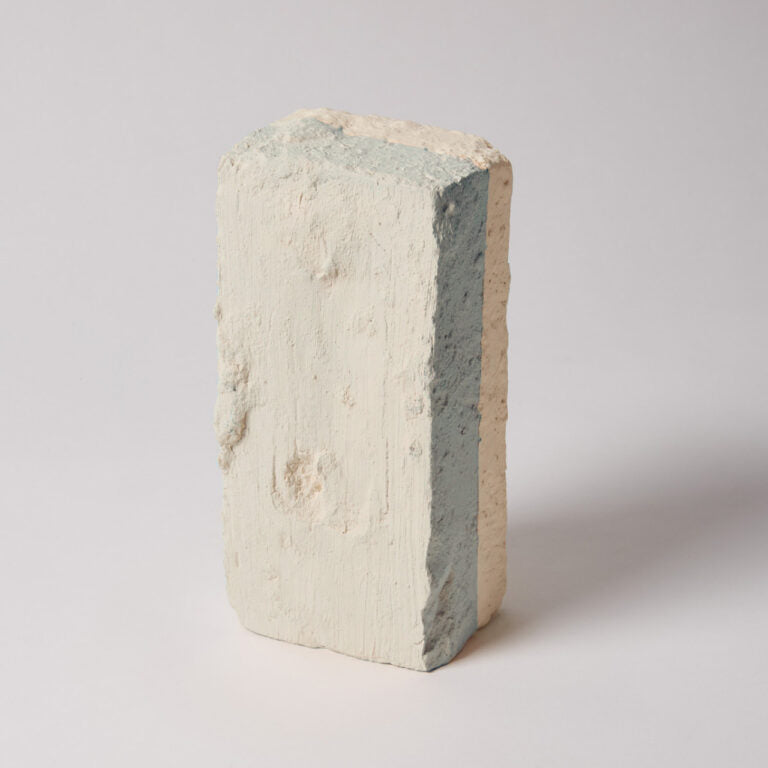 Concrete block with visible layers on a white background